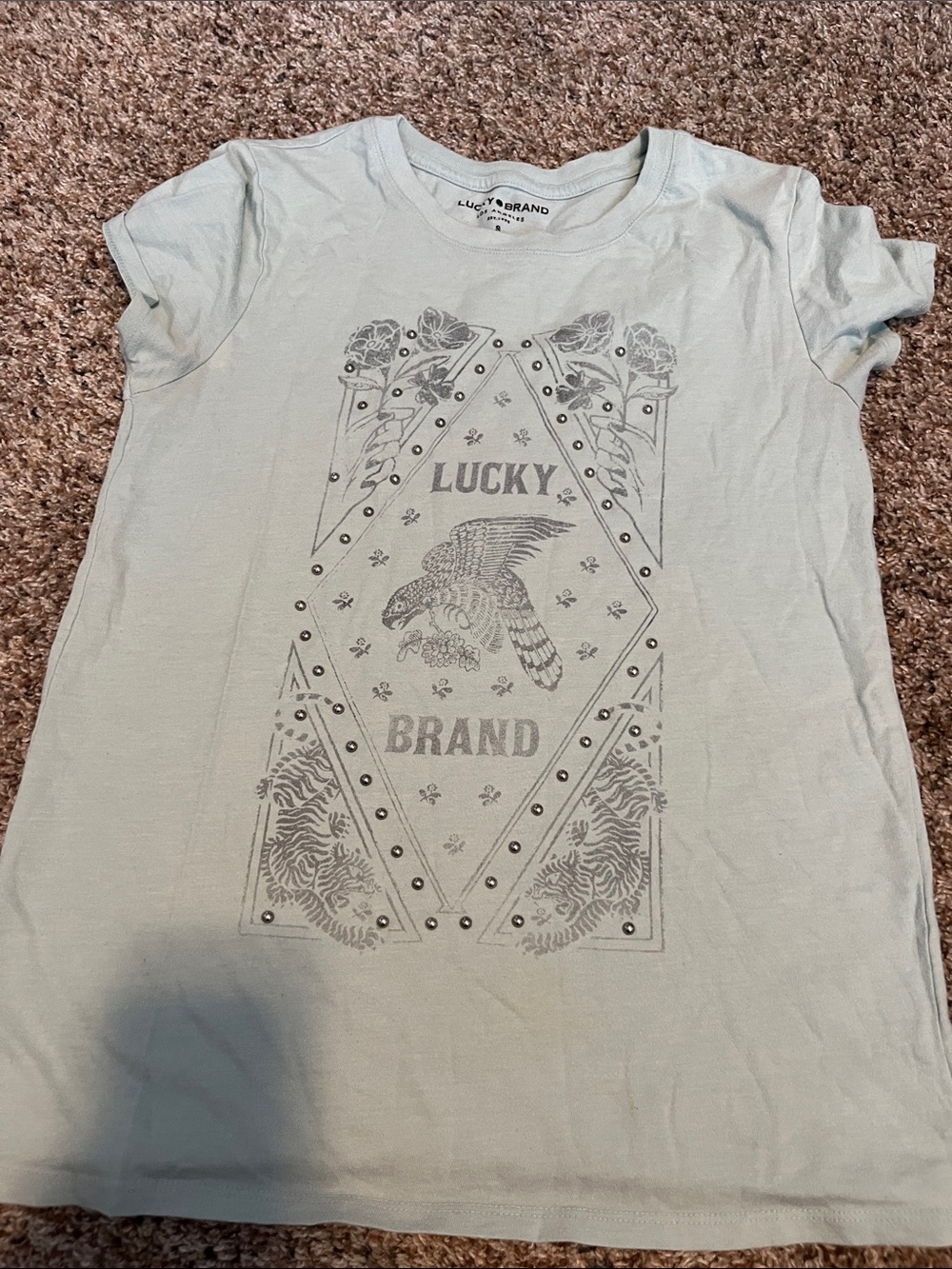 Lucky brand teal shirt with bird graphic and flowers.